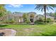 Inviting single-story home with lush landscaping and a well-manicured lawn at 2140 Lilypad Ln, Windermere, FL 34786