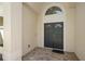 Elegant double front door with an arched transom window and brick entryway at 2140 Lilypad Ln, Windermere, FL 34786