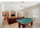 Spacious game room including a pool table, large TV and comfortable seating area at 2140 Lilypad Ln, Windermere, FL 34786