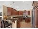 Gourmet kitchen with dark wood cabinets, granite countertops, and stainless steel appliances at 2140 Lilypad Ln, Windermere, FL 34786