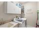 Laundry room features a utility sink, cabinetry for storage and a modern washer and dryer at 2140 Lilypad Ln, Windermere, FL 34786