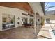 A covered patio area with stylish dining set and ceiling fan, offering an ideal space for outdoor relaxation and dining at 2140 Lilypad Ln, Windermere, FL 34786