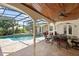 Inviting screened-in pool area with a spa and outdoor dining space, perfect for entertaining and relaxation at 2140 Lilypad Ln, Windermere, FL 34786