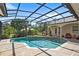Stunning screened-in pool with a spa, complemented by lush landscaping for a private and tranquil outdoor oasis at 2140 Lilypad Ln, Windermere, FL 34786