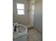 Bathroom with a white tiled shower and simple sink at 227 Strawberry Ln, Daytona Beach, FL 32117