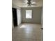 Modest bedroom with a bright window and a double-door closet at 227 Strawberry Ln, Daytona Beach, FL 32117