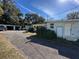 Exterior view of home with a long driveway and detached garage at 227 Strawberry Ln, Daytona Beach, FL 32117