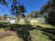 Exterior of a quaint home with a well-manicured front lawn on a sunny day at 227 Strawberry Ln, Daytona Beach, FL 32117