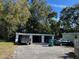 Detached three car garage at the end of a long driveway with mature trees at 227 Strawberry Ln, Daytona Beach, FL 32117