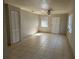 Simple living room with tiled floors, ceiling fan, and a bright window at 227 Strawberry Ln, Daytona Beach, FL 32117