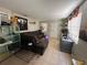 Open living room with tile floors, a dark sectional sofa, and natural light at 227 Strawberry Ln, Daytona Beach, FL 32117