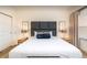 Bright bedroom featuring a padded headboard, neutral walls, and contemporary bedside tables at 2653 Roadster Ln, Kissimmee, FL 34746