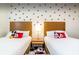 themed bedroom featuring two twin beds adorned with colorful Mickey Mouse decor at 2653 Roadster Ln, Kissimmee, FL 34746