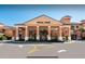 Exterior of the Regal Oaks clubhouse featuring a covered entrance with decorative pillars and well-maintained landscaping at 2653 Roadster Ln, Kissimmee, FL 34746