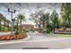 Elegant community entrance featuring lush landscaping and inviting signage at 2653 Roadster Ln, Kissimmee, FL 34746