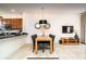 Contemporary dining area featuring modern lighting, neutral walls, and adjacent kitchen at 2653 Roadster Ln, Kissimmee, FL 34746