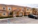Charming two-story townhome with a red tile roof and manicured landscaping at 2653 Roadster Ln, Kissimmee, FL 34746