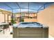 Hot tub on a screened-in patio offering a private and comfortable space to relax and unwind outdoors at 2653 Roadster Ln, Kissimmee, FL 34746