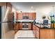 Modern kitchen with stainless steel appliances, granite countertops, and wooden cabinets at 2653 Roadster Ln, Kissimmee, FL 34746