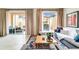 Bright living room featuring tile floors, comfy seating, and access to the outdoor patio at 2653 Roadster Ln, Kissimmee, FL 34746