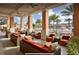 Relaxing outdoor lounge with comfortable seating overlooking the pool and beautiful landscape at 2653 Roadster Ln, Kissimmee, FL 34746