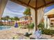 Inviting poolside cabana with comfortable seating and views of the pool and resort at 2653 Roadster Ln, Kissimmee, FL 34746
