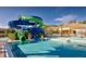 Community pool area with an elaborate waterslide, poolside lounge area and various amenities for Gathering fun at 2653 Roadster Ln, Kissimmee, FL 34746