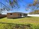 Spacious backyard with green grass, a screened-in lanai, and partial fencing in a serene setting at 2936 Woodcrest Ln, Lakeland, FL 33805