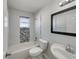 Modern bathroom with a mosaic tile accent wall, white fixtures, and a stylish vanity with natural light at 2936 Woodcrest Ln, Lakeland, FL 33805