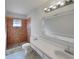 Bathroom featuring tiled shower, vanity with sink, and decorative mirror creating a functional space at 2936 Woodcrest Ln, Lakeland, FL 33805