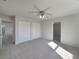 Bedroom with carpeted floor, ceiling fan, and large closet providing ample storage space at 2936 Woodcrest Ln, Lakeland, FL 33805