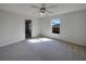 Cozy bedroom with plush carpet, ceiling fan, and ample natural light from the window at 2936 Woodcrest Ln, Lakeland, FL 33805