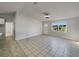 Bright living room features tile flooring, a ceiling fan, and a view of the outdoors through a window at 2936 Woodcrest Ln, Lakeland, FL 33805