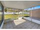 Enclosed patio with tile floor and view of the spacious, fenced backyard, providing a perfect outdoor living space at 2936 Woodcrest Ln, Lakeland, FL 33805