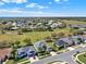 This aerial view showcases a community with a golf course, well-maintained homes, and green spaces on a bright day at 3624 Belle Rose Dr, Leesburg, FL 34748