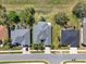 An aerial view showcases a well-maintained home with lush landscaping and a neatly manicured lawn in a neighborhood setting at 3624 Belle Rose Dr, Leesburg, FL 34748