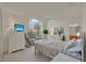Bedroom with cathedral ceiling, bed, and large window at 3624 Belle Rose Dr, Leesburg, FL 34748