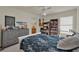 Bedroom with large bed, full dresser, shelving and desk at 3624 Belle Rose Dr, Leesburg, FL 34748