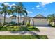 Attractive single-story home featuring a two-car garage, lush landscaping, and a well-maintained lawn at 3624 Belle Rose Dr, Leesburg, FL 34748