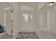 Bright foyer with decorative front door, tile floors, and transom window at 3624 Belle Rose Dr, Leesburg, FL 34748
