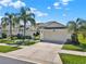 Charming single-story home featuring a manicured lawn, mature palms, and a spacious two-car garage at 3624 Belle Rose Dr, Leesburg, FL 34748