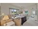 Bright living room with high ceilings, neutral colors, and sliding glass doors to the outdoor area at 3624 Belle Rose Dr, Leesburg, FL 34748