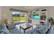 Relaxing living room featuring a built-in entertainment center and sliding glass doors to the backyard at 3624 Belle Rose Dr, Leesburg, FL 34748
