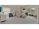 Spacious bedroom boasts ample natural light, neutral decor, and comfortable seating at 3624 Belle Rose Dr, Leesburg, FL 34748