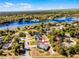 Aerial view of home near a lake, surrounded by lush greenery and beautiful scenery at 380 Dorset Ave, Deltona, FL 32738
