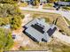 Birds eye view of home with solar panels on roof and spacious surrounding property at 380 Dorset Ave, Deltona, FL 32738
