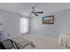 Cozy bedroom with a ceiling fan, neutral decor, and ample natural light from a window at 380 Dorset Ave, Deltona, FL 32738