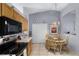 The kitchen offers black appliances and a cozy dining area with an ornate chandelier at 380 Dorset Ave, Deltona, FL 32738