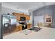 Well-lit kitchen with an island featuring a sink and stainless steel refrigerator at 380 Dorset Ave, Deltona, FL 32738
