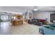 Open-concept living space with kitchen island, dining area, and comfortable seating at 380 Dorset Ave, Deltona, FL 32738